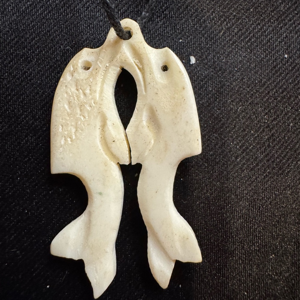 Carved Dolphin Fish Pendant Necklace on fabric chain.